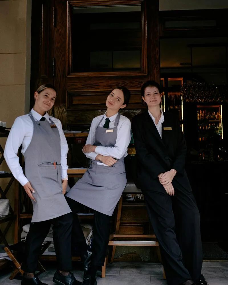 Equipo de servicio hotelero en uniforme formal, comunidad Libertadora Córdoba